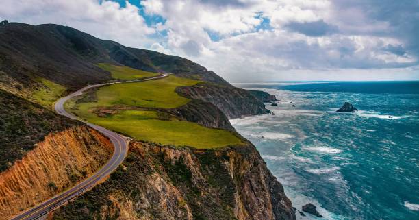 istock Aerial view of sea breaking beach with greenery mountains 1446418691