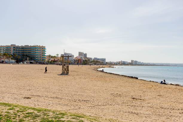 istock Sandy beach with city buildings in the background. Spain. 1446419191