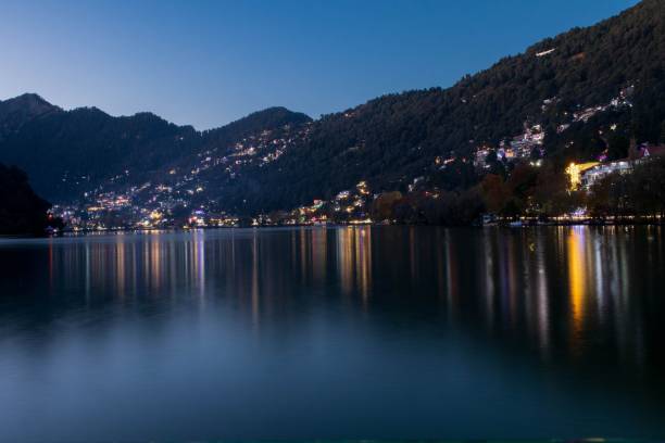 istock Illuminated town by the lake in a mountainous area 1446419919