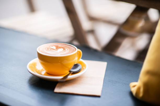 istock High-angle shot of cappuccino in a yellow coffee cup on the table 1446419943