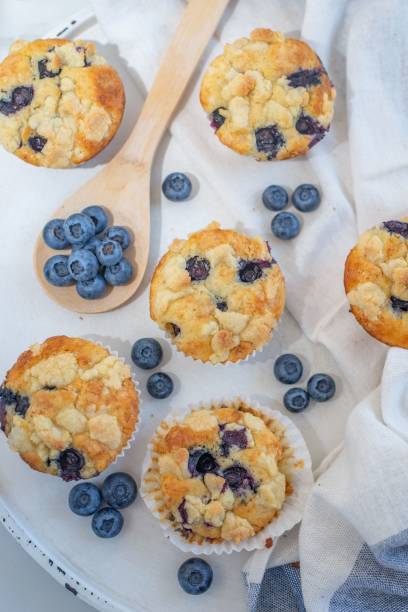 istock Blueberry muffins on a white cloth in the table 1446420176