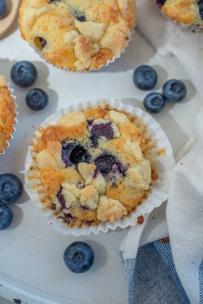 istock Blueberry muffins on a white cloth in the table 1446420198