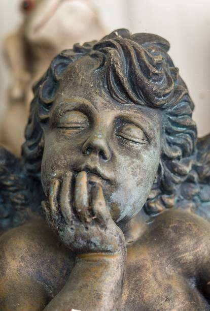 istock Statue of a baby sleeping with its hand on its head 1446420312