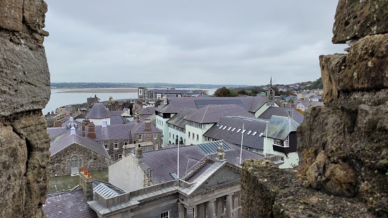 A beautiful shot of the roofs of houses in Caernarfon under gray cloudy sky