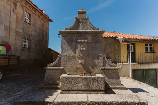 Photo of Ancient water fountain in Castelo Mendo, Portugal on a sunny day