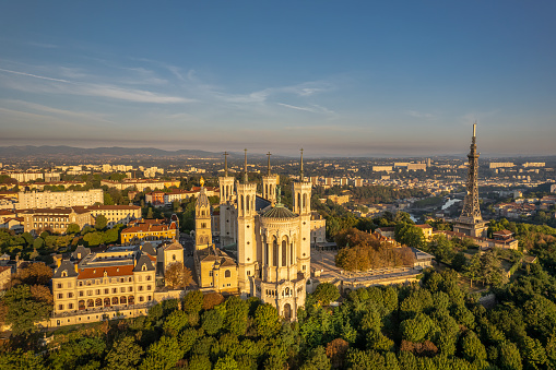 The drone panoramic view of The Basilica of Notre-Dame de Fourvière and Metallic tower on the top of hill.