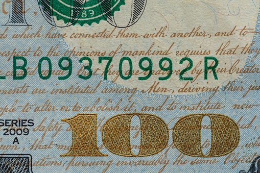 A closeup of a one hundred dollar bill banknote