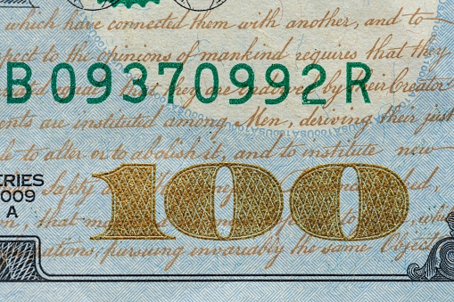 A closeup of a one hundred dollar bill banknote