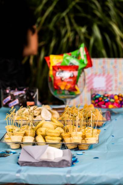 istock Yellow cupcakes with blur snacks packages on the table at night 1446424802