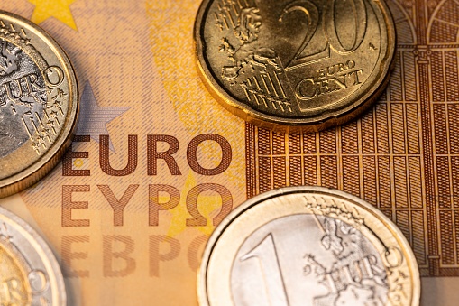 A top view of Euro coins and 200 euro banknotes on a stack