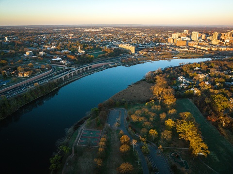 An aerial shot of the river surrounded by trees and buildings, New Brunswick, USA