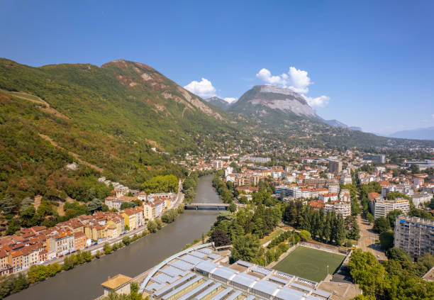 The drone aerial view of the Isère River and Grenoble city, France. Grenoble is the prefecture and largest city of the Isère department in the Auvergne-Rhône-Alpes region of southeastern France. isere river stock pictures, royalty-free photos & images