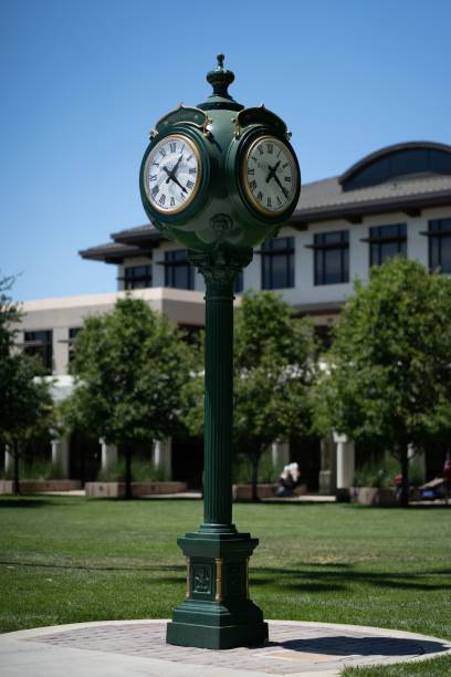 istock Vertical shot of a green outdoors clock tower in the park 1446427064