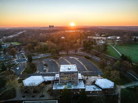 A drone view of a city skyline with buildings and highways at sunrise in New Brunswick, Rutgers, Hub City, USA