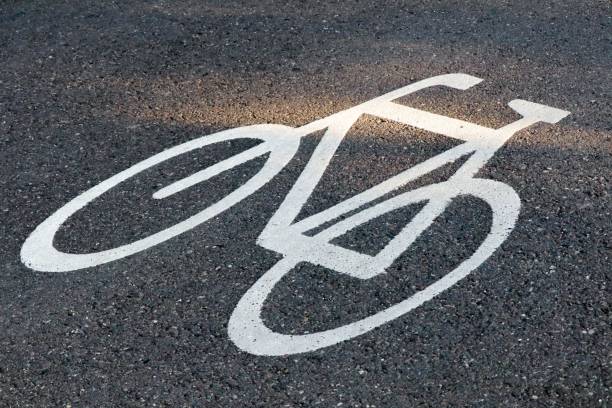 istock Bicycle painted on asphalt indicating a bicycle road 1446428621