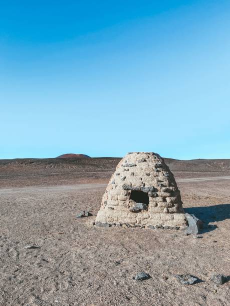 Vertical shot of an old adobe oven made of volcanic stones at Carachi Pampa volcano, Catamarca A vertical shot of an old adobe oven made of volcanic stones at Carachi Pampa volcano, Catamarca stove oven adobe outdoors stock pictures, royalty-free photos & images