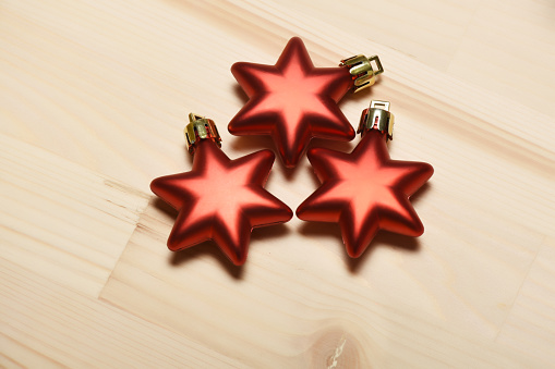Star shape Christmas ornaments on the wood background