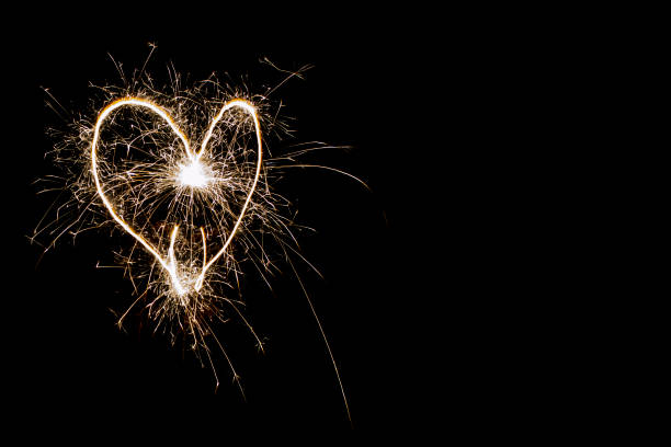 istock Hearts on a dark background drawn by a sparkler. 1446429824