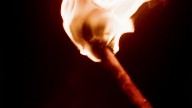 Burning torch at night.