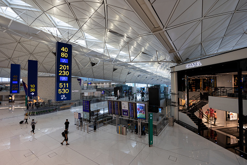 Hong Kong - November 21, 2022 :  People at Hong Kong International Airport. The airport has been commercially operational since 1998. It is operated by the Airport Authority Hong Kong.