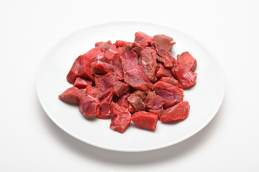 Chopped meats in a plate on the white background. Raw meat