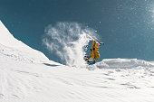 Snowboarder make jump and flip at ski resort