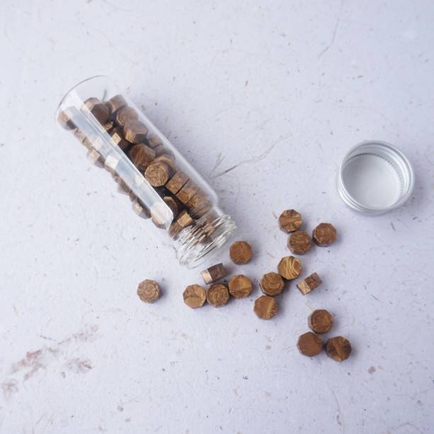 istock Wax bead in glass bottle 1446446210