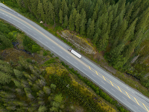 Aerial shot of a Transport truck driving along Highway 99, BC, Canada