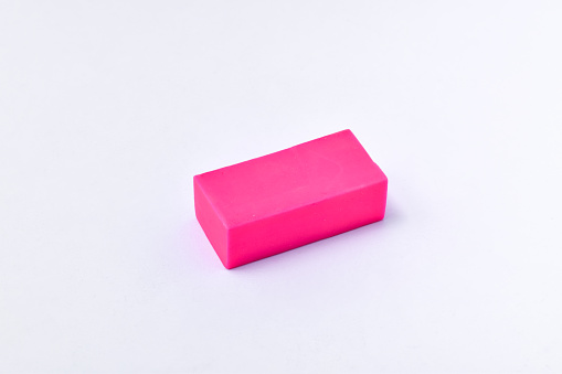 Pink eraser isolated on white background, stationery for writing