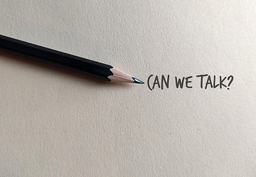 Pencil on copy space craft paper with text written CAN WE TALK?, concept of boss , manager, partners or friends approach to have a serious talk or difficult conversation to solve conflicts or relationship issues