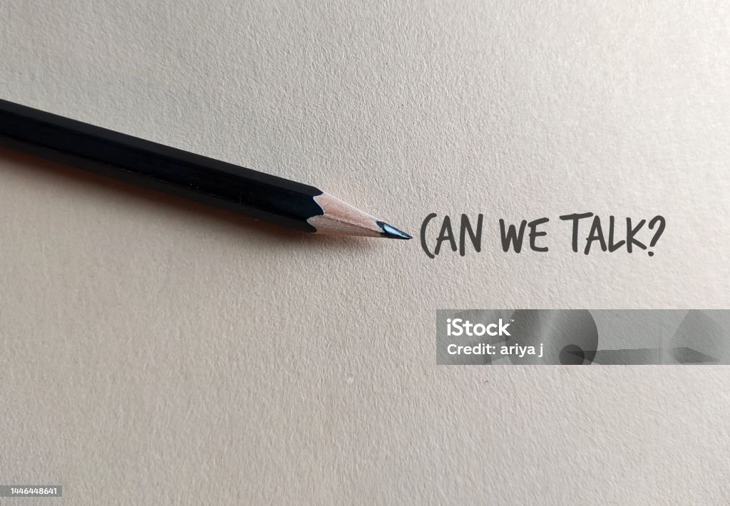 Pencil on copy space craft paper with text written CAN WE TALK?, concept of boss , manager, partners or friends approach to have a serious talk or difficult conversation to solve conflicts or relationship issues Discussion Stock Photo