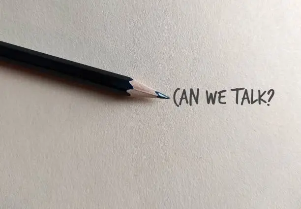 Photo of Pencil on copy space craft paper with text written CAN WE TALK?, concept of boss , manager, partners or friends approach to have a serious talk or difficult conversation to solve conflicts or relationship issues