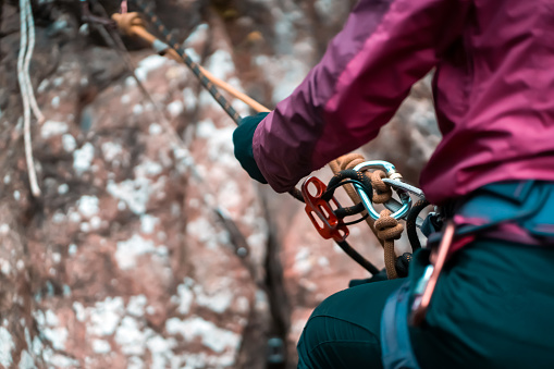 Strong woman climbing on boulder wall