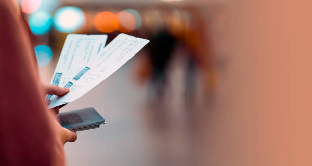 istock Girl holds tickets, boarding passes for a flight. 1446454695