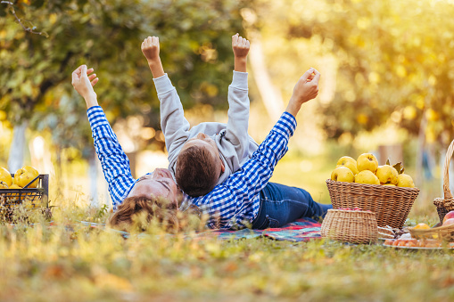 Mother and son playing outside in a park.