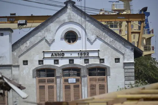old european style building that reads Anno 1892. the building is in the port of surabaya