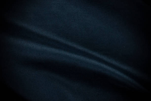 istock Nice dark blue silk satin background. Soft folds on shiny fabric and cloth in Luxury texture style background with copy space for text concepts. 1446457317