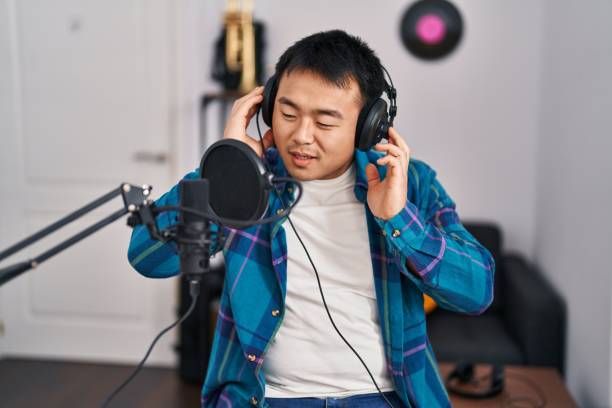 istock Young chinese man singer singing song at music studio 1446458460
