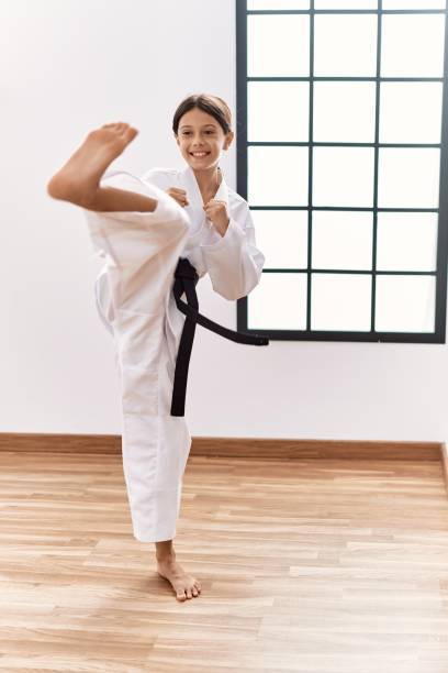 istock Young hispanic girl doing martial arts at training studio 1446458651