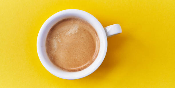 istock One cup of coffee with milk over yellow background 1446459623