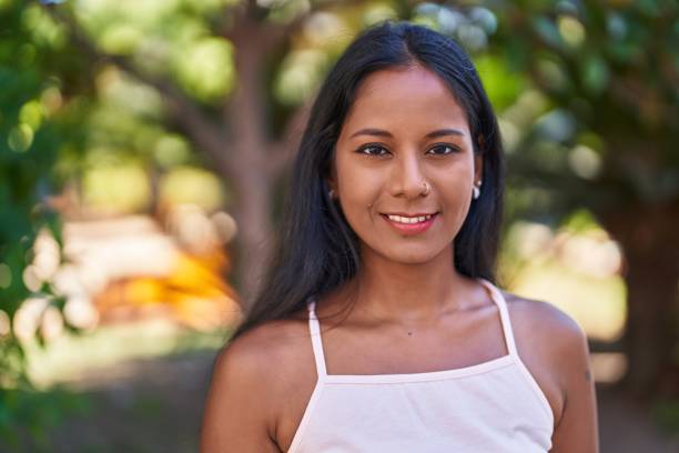 istock Young beautiful woman smiling confident standing at park 1446459874