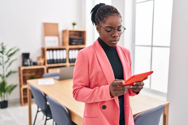 istock African american woman business worker using touchpad standing at office 1446460233