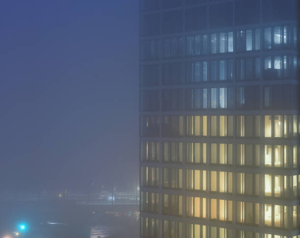 istock illuminated office tower on a foggy night 1446462697