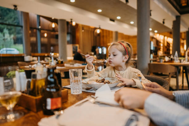 istock Little girl eating pancake in restaurant 1446464311