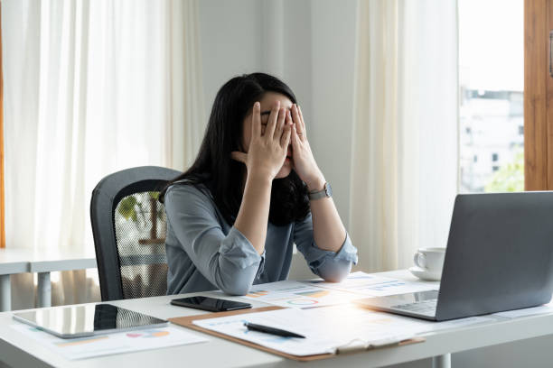 istock Tired stressed businesswoman feeling strong headache massaging temples exhausted from overwork, fatigued overwhelmed lady. Executive worker suffering from pain in head or chronic migraine in office 1446466829