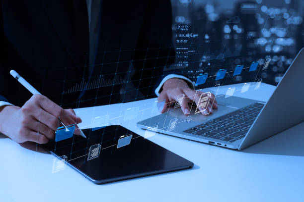 istock To effectively manage files, a man employs a Document Management System (DMS), an online documentation database, and process automation. 1446467552