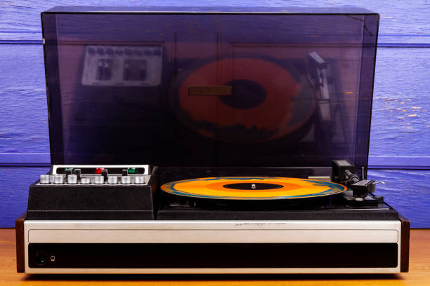 istock Vintage turntable vinyl record player with blue and orange vinyl 1446468988