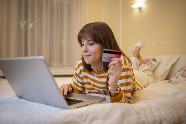 istock Cheerful  woman doing online shopping 1446469017