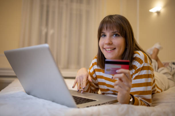 istock Cheerful  woman doing online shopping 1446469026
