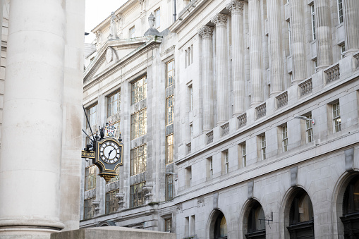 An ornate clock on the exterior of a building on Fleet Street in the City of London, UK.